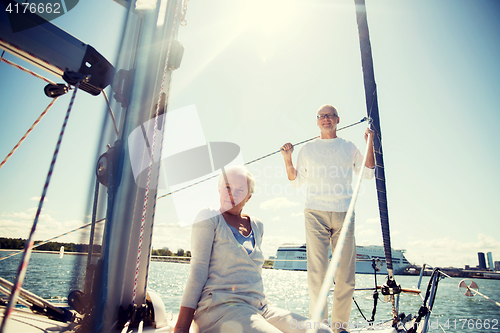 Image of senior couple hugging on sail boat or yacht in sea