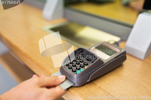 Image of close up of hand inserting bank card to terminal