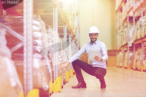 Image of happy businessman with tablet pc at warehouse