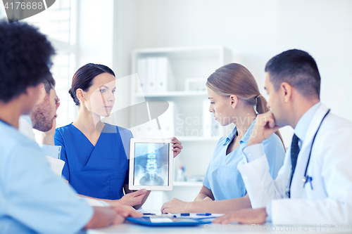 Image of group of doctors with x-ray on tablet pc at clinic