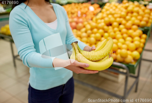 Image of woman with bananas at grocery store