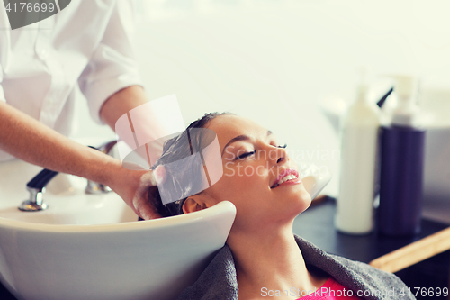 Image of happy young woman at hair salon