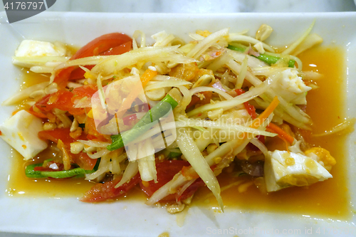 Image of Green papaya salad on white plate