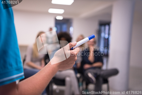 Image of close up of teacher hand with marker