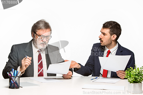 Image of The two colleagues working together at office on white background.
