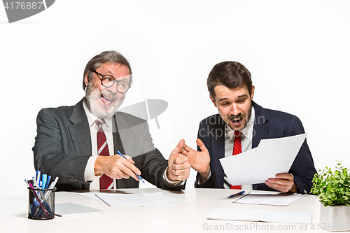 Image of The two colleagues working together at office on white background.