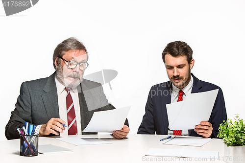 Image of The two colleagues working together at office on white background.