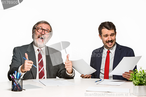 Image of The two colleagues working together at office on white background.