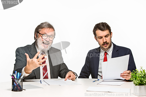 Image of The two colleagues working together at office on white background.