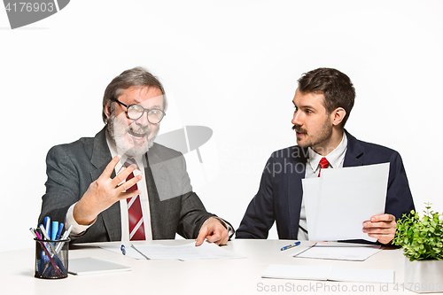 Image of The two colleagues working together at office on white background.