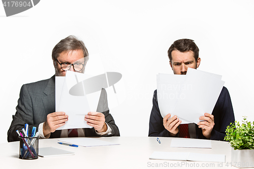 Image of The two colleagues working together at office on white background.