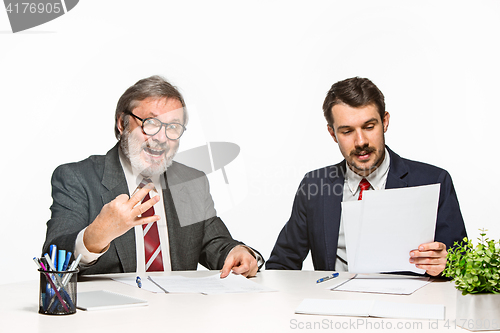 Image of The two colleagues working together at office on white background.