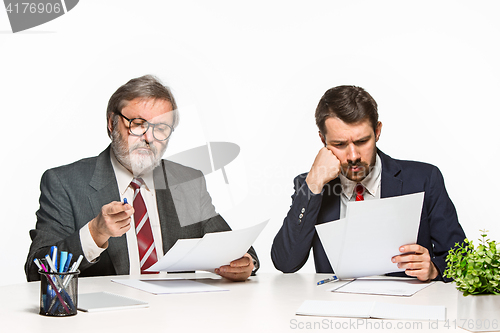 Image of The two colleagues working together at office on white background.