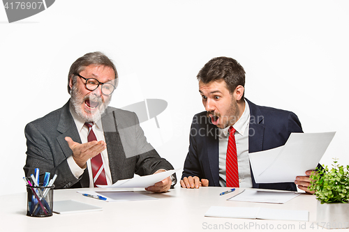 Image of The two colleagues working together at office on white background.