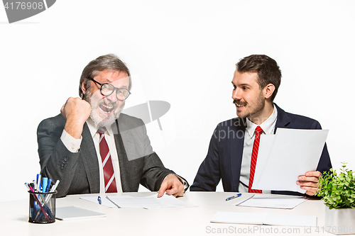 Image of The two colleagues working together at office on white background.