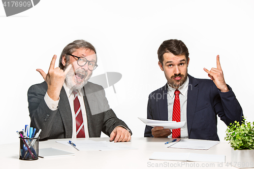 Image of The two colleagues working together at office on white background.