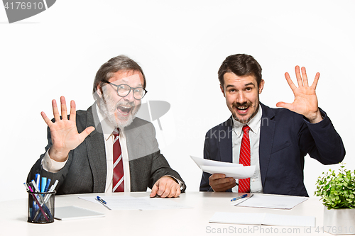 Image of The two colleagues working together at office on white background.