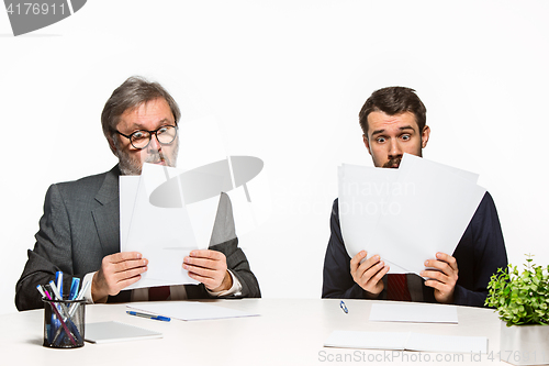 Image of The two colleagues working together at office on white background.