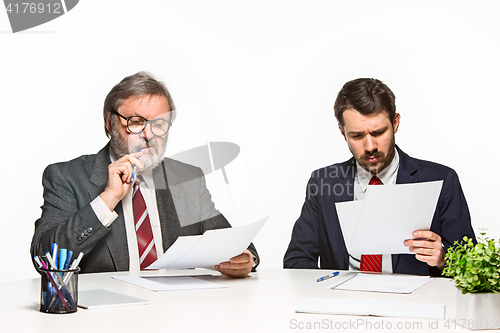 Image of The two colleagues working together at office on white background.