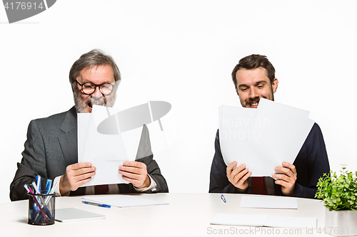 Image of The two colleagues working together at office on white background.