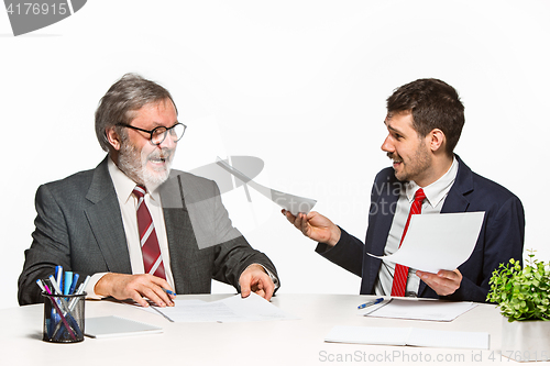 Image of The two colleagues working together at office on white background.