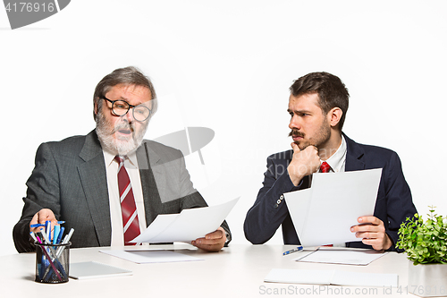 Image of The two colleagues working together at office on white background.