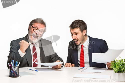 Image of The two colleagues working together at office on white background.