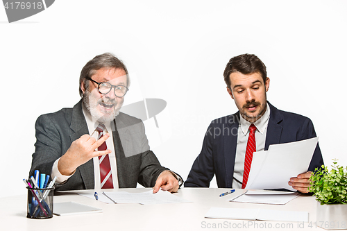 Image of The two colleagues working together at office on white background.