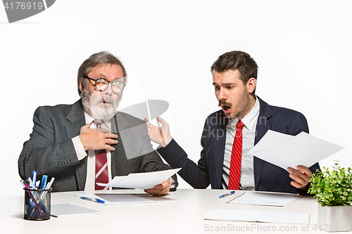 Image of The two colleagues working together at office on white background.