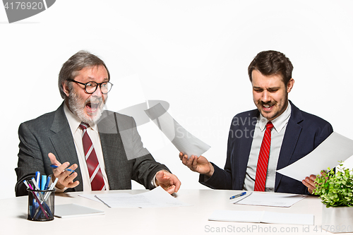 Image of The two colleagues working together at office on white background.