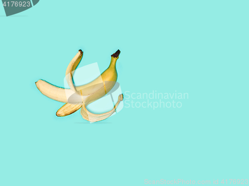 Image of Single banana against blue background