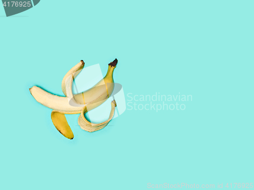 Image of Single banana against blue background