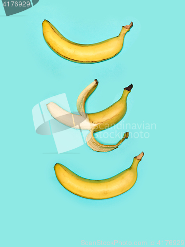 Image of The group of bananas against blue background