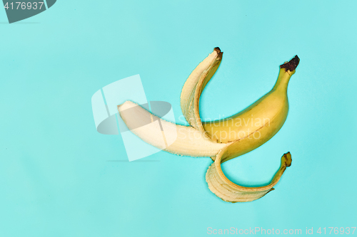 Image of Single banana against blue background