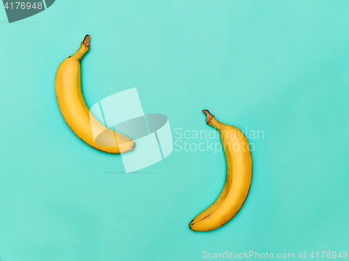 Image of The two bananas against blue background