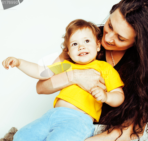 Image of young pretty stylish mother with little cute daughter hugging, happy smiling family, lifestyle people concept 