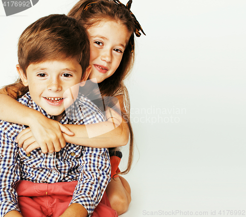 Image of little cute boy and girl hugging playing on white background, ha