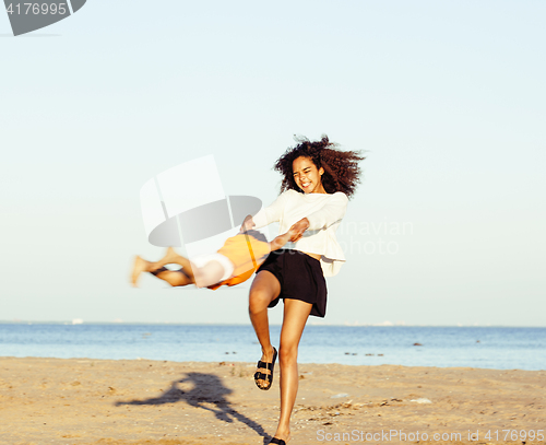 Image of pretty diverse nation and age friends on sea coast having fun, lifestyle people concept on beach vacations 