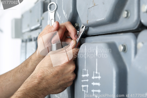 Image of Electrician repairs installations.