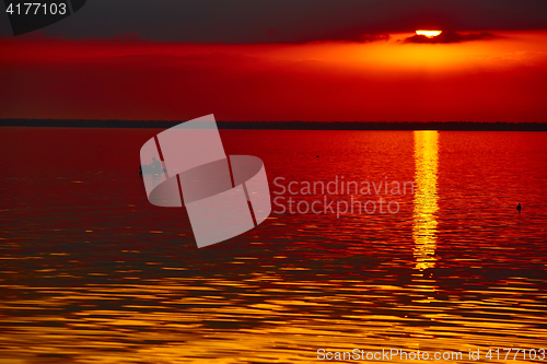 Image of good red sunset over darken sea