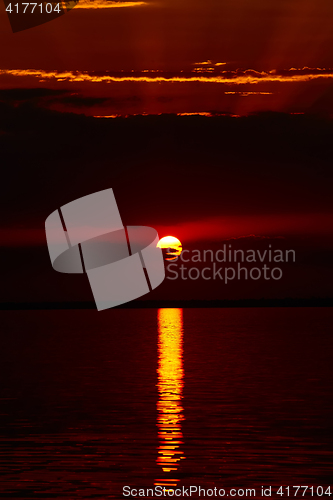 Image of Sunrise in the sea with soft wave and cloudy