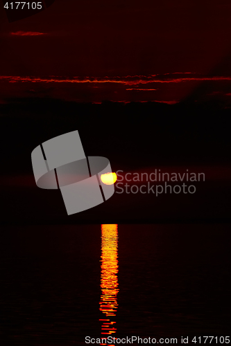 Image of Sunrise in the sea with soft wave and cloudy