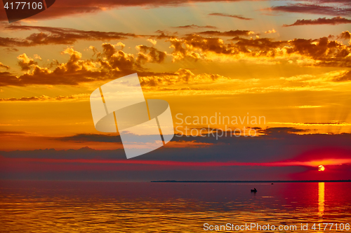 Image of good red sunset over darken sea