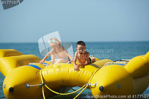 Image of two happy kids playing on the boat at summer day