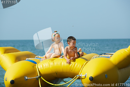 Image of two happy kids playing on the boat at summer day