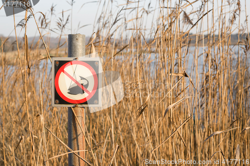 Image of Fishing forbidden sign by a lake