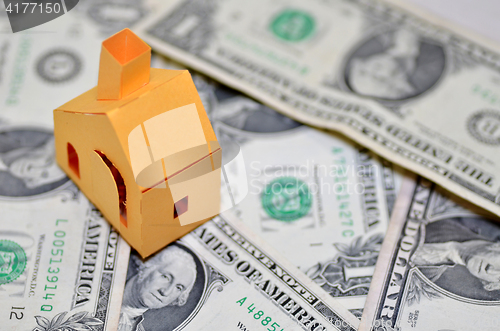 Image of Miniature paper made house stand on  money