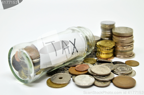 Image of Tax lable in a glass jar with coins spilling out