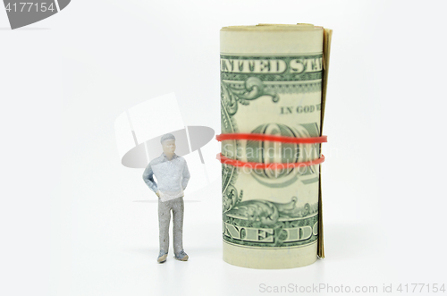 Image of Figure of businessman and one dollar bill