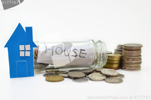 Image of House model and stacks of coins